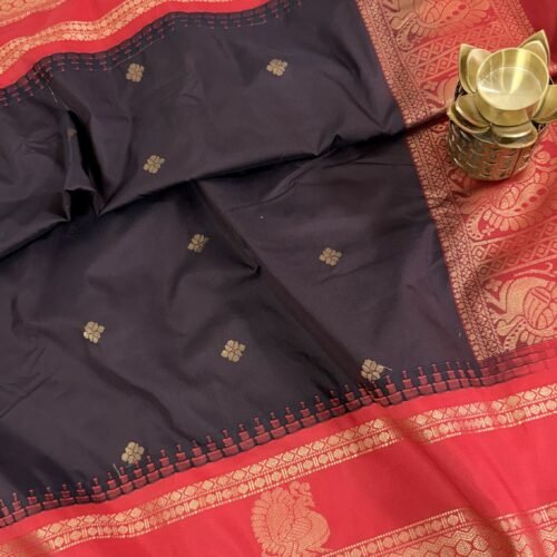 black semi gadwal saree with red contrast zari border and traditional weaving