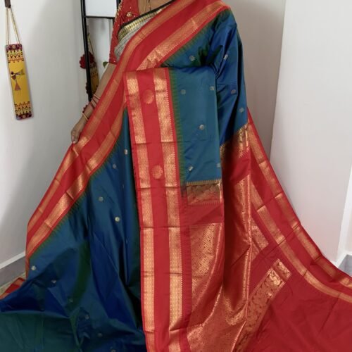 teal blue semi gadwal saree with rust orange zari border and traditional weaving