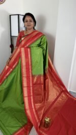 green semi gadwal saree with red contrast zari border and rich pallu