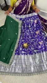 purple banarasi semi stitched lehenga with green dupatta and silver zari work
