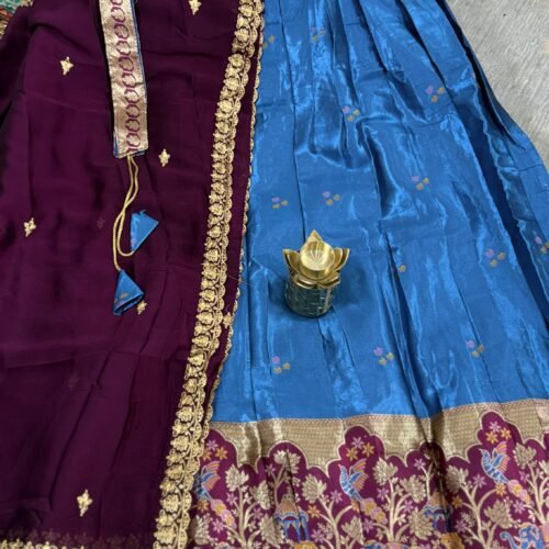 maroon and sky blue half saree with kanchi tissue lehenga and elephant peacock border
