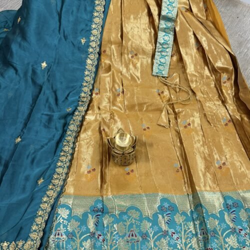 gold and teal half saree with kanchi tissue lehenga and elephant peacock border design