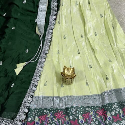 lime yellow and bottle green pastel half saree with kanchi tissue lehenga and peacock border